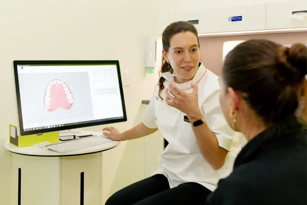 Urban Smile Oral Health Therapist showing a bride-to-be her clear aligner treatment plan at Urban Smile during her wedding prep