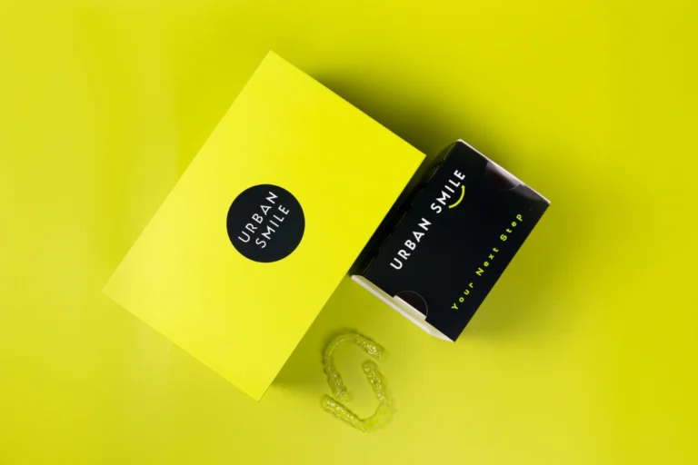 Photo of Urban Smile Clear Aligner box and refinement aligner box with clear aligners next to them