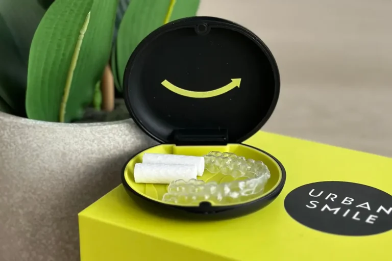 Clean Urban Smile clear aligners sitting in their case on top of the Urban Smile aligner box