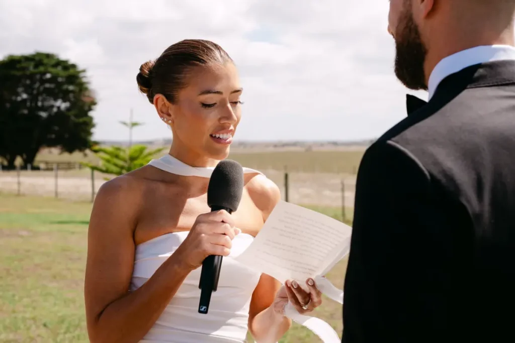 Eliza Boyd saying her wedding vows with a glowing wedding smile