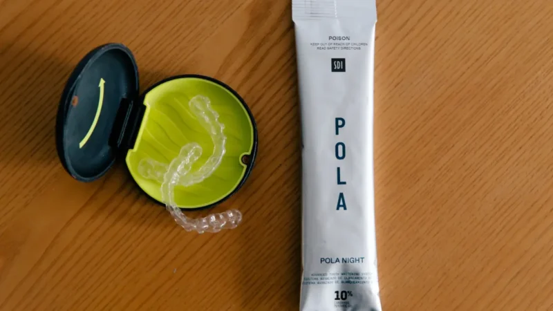 Pola Night Take-Home Teeth Whitening packet next to an Urban Smile custom whitening tray case
