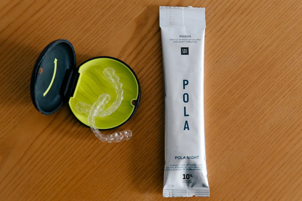 Pola Night Take-Home Teeth Whitening packet next to an Urban Smile custom whitening tray case