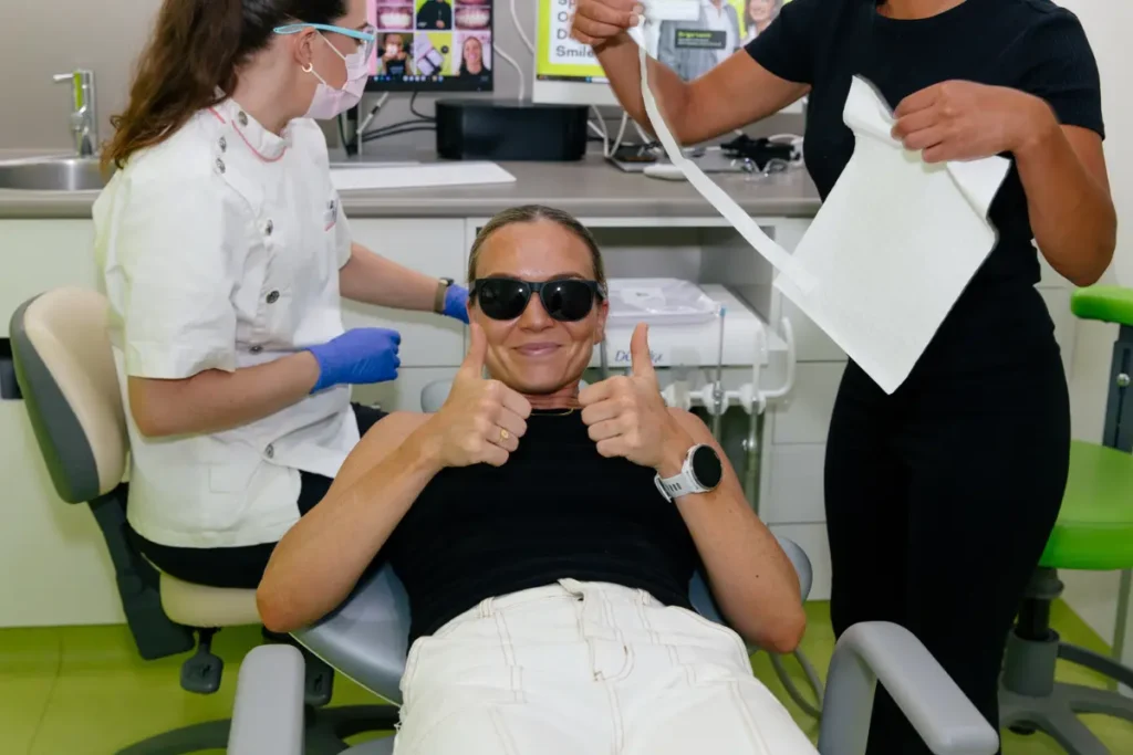 Emily Bates giving a thumbs up in the treatment room at Urban Smile Orthodontics