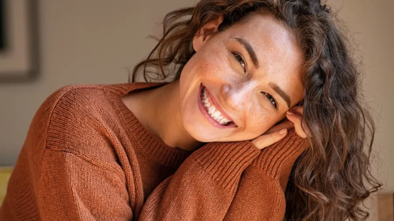 Woman in cosy brown jumper smiling