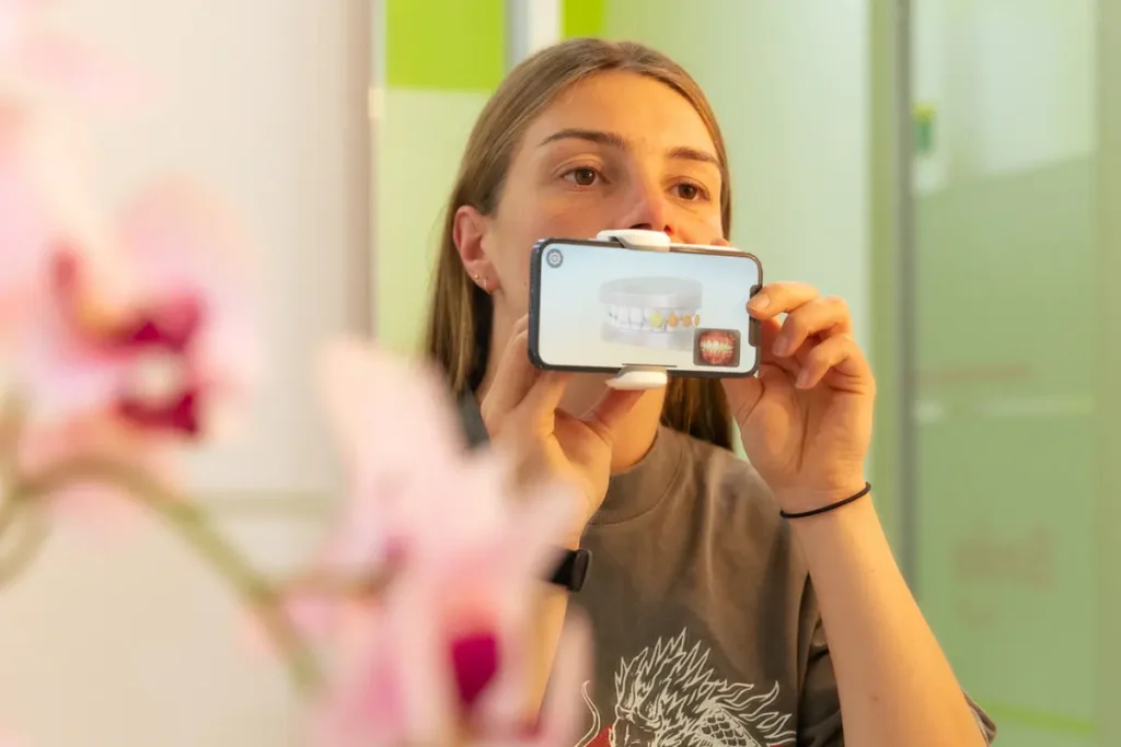 Urban Smile ambassador Tahlia Fellows doing a Dental Monitoring scan