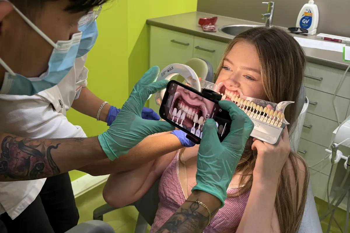 Patient getting shade matched for in-chair whitening in Urban Smile treatment room
