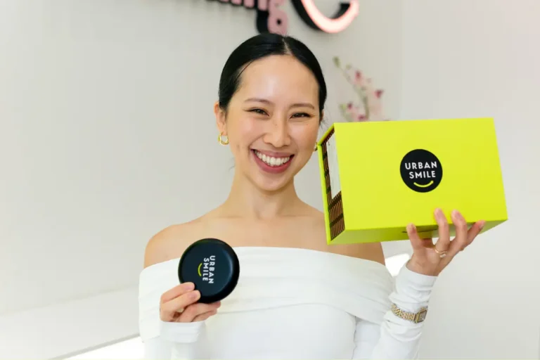 Influencer @lovecherriiee holding up her Urban Smile clear aligner box and aligner case